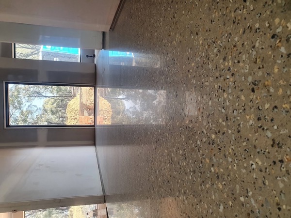 A close view of gold and grey stone exposed across a concrete surface